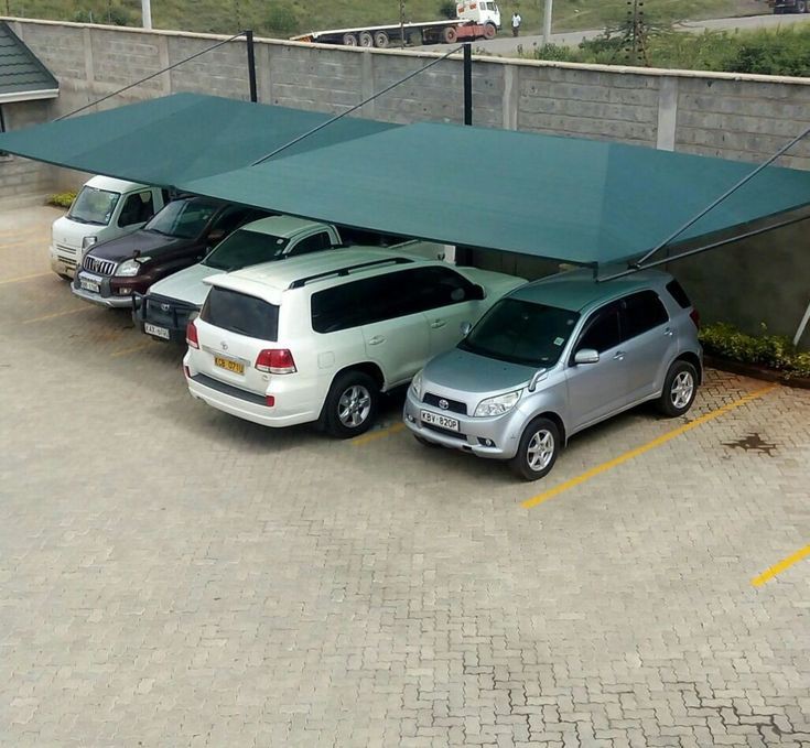 Single-bay steel-framed car shade with shade-net roofing